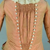 Girl’s dress, salmon and maroon silk taffeta check with bustle, 1880s, detail of front panel