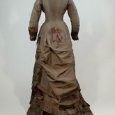 Dress, asymmetrical natural form brown silk taffeta and satin, c. 1880, back view