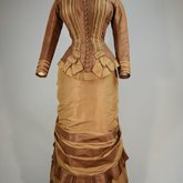 Dress, brown and tan silk taffeta with cuirass bodice and bustle, c. 1883, front view