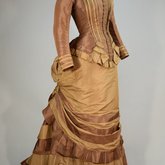 Dress, brown and tan silk taffeta with cuirass bodice and bustle, c. 1883, side view