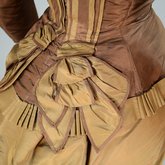 Dress, brown and tan silk taffeta with cuirass bodice and bustle, c. 1883, detail of peplum