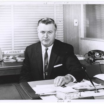 J.W. Herbert Sitting At His desk