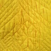 Quilted petticoat, yellow silk, 18th century, detail of quilted flower