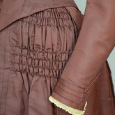 Wedding dress, maroon silk faille with sleeve puffs, 1893, detail of skirt ruche and cuff
