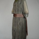 Dress, dark olive chiffon with brown satin sash over brown satin foundation, c. 1922, quarter view