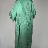 Dress, emerald green silk crepe with steel beads in Art Nouveau patterns, 1920s, quarter view