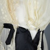 Dress, embroidered voile over a black silk satin skirt, 1910s, detail of overlapping openings