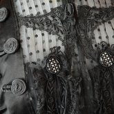 Mourning dress, striped black silk with black embroidered appliqués, c. 1900, detail of coils and buttons