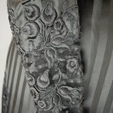 Mourning dress, striped black silk with black embroidered appliqués, c. 1900, detail of sleeve appliqué