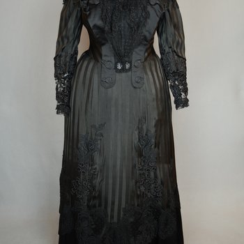 Mourning dress, striped black silk with black embroidered appliqués, c. 1900, front view