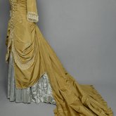 Dress, deep yellow silk taffeta with blue silk satin pleats and long train,1877-1882 , quarter view with restored seams and darts