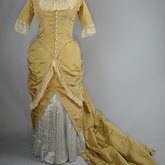 Dress, deep yellow silk taffeta with blue silk satin pleats and long train,1877-1882, front view with seams let out