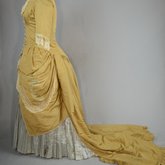 Dress, deep yellow silk taffeta with blue silk satin pleats and long train,1877-1882, side view with seams let out