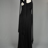 Evening gown, sleeveless, pin-tucked black crepe with long black cord tassels, 1930s, side view