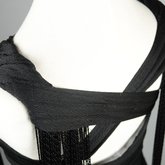 Evening gown, sleeveless, pin-tucked black crepe with long black cord tassels, 1930s, detail of straps