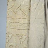Dress, taupe silk crepe with short sleeves and overskirt embroidered with cord and gold beads, c. 1920, detail of embroidery exterior and interior