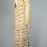 Sheath dress with vest, sleeveless, pale gold and tangerine chiffon with rows of bugle beads, c. 1923, quarter view