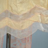 Sheath dress, sleeveless with irregular hem, apricot chiffon with pink and coral beads, c. 1925, detail of scalloped underdress hem