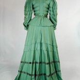 Suit, green wool with braid and velvet, c. 1906, back view