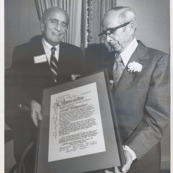 Dr. Benjamin Bugbee presenting Dr. Carroll Osgood an appreciation award at Dr. Osgood's retirement, November 19, 1975