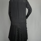 Dress, black silk with dropped waist and scalloped pleated panels, 1920s, back view