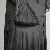 Dress, black silk with dropped waist and scalloped pleated panels, 1920s, detail of skirt