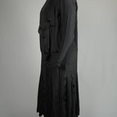 Dress, black silk with dropped waist and scalloped pleated panels, 1920s, side view