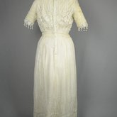 Dress, machine embroidered white muslin with a lace yoke and sleeves, c. 1905-1910, back view