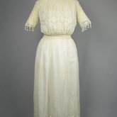 Dress, machine embroidered white muslin with a lace yoke and sleeves, c. 1905-1910, front view