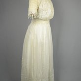 Dress, machine embroidered white muslin with a lace yoke and sleeves, c. 1905-1910, side view