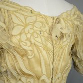 Evening gown, pale yellow faille with Chantilly lace and a bobbinet overlay appliquéd with Art Nouveau lilies, c. 1905, detail of back bodice