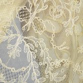 Evening gown, pale yellow faille with Chantilly lace and a bobbinet overlay appliquéd with Art Nouveau lilies, c. 1905, detail of Chantilly lace