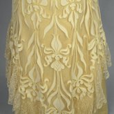Evening gown, pale yellow faille with Chantilly lace and a bobbinet overlay appliquéd with Art Nouveau lilies, c. 1905, detail of skirt