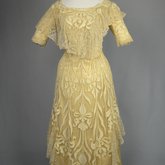 Evening gown, pale yellow faille with Chantilly lace and a bobbinet overlay appliquéd with Art Nouveau lilies, c. 1905, front view