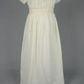 Infant’s dress, white on white checked batiste with an embroidered ribbon waist, c. 1897, front view