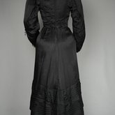 Suit, black ottoman silk trimmed with Maltese crosses and tassels of silk-wrapped beads, 1915-1917, back view