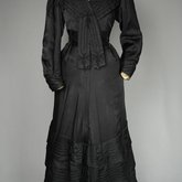 Suit, black ottoman silk trimmed with Maltese crosses and tassels of silk-wrapped beads, 1915-1917, front view