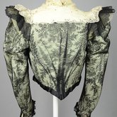 Bodice, black lace over green faille and pale green organdy with shoulder frills, pink beaded flowers, and sequins, c. 1898, back view