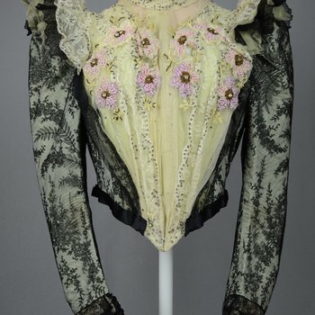 Bodice, black lace over green faille and pale green organdy with shoulder frills, pink beaded flowers, and sequins, c. 1898, front view