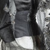 Dress, black silk satin and point d’esprit bobbinet with organdy and cord appliqué, c. 1915-1918, detail of side opening in outer layers, with high plain bobbinet and point d’esprit attachments