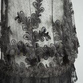 Dress, black silk satin and point d’esprit bobbinet with organdy and cord appliqué, c. 1915-1918, detail of skirt