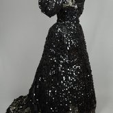 Evening gown, Marie Lamy of Paris, black silk satin with a black-sequined overlay and short puffed sleeves, 1890s, quarter view