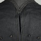 Jacket, black wool with large scalloped revers, pouched front, and topstitched silk trim, c. 1902, detail of back of collar