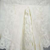 Shirtwaist, white embroidered cotton with ruffles flanking the buttoned front, 1884, detail of peplum