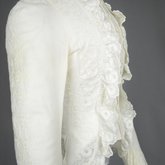 Shirtwaist, white embroidered cotton with ruffles flanking the buttoned front, 1884, detail of ruffle