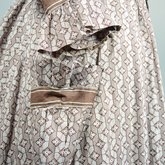 Housedress, cotton printed with a brown geometric pattern, separate underskirt, c. 1875, detail of cuff and pocket