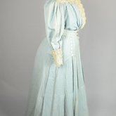 Dress, blue cotton with pouched bodice, tailored skirt, lace yoke, and matching belt, c. 1905, quarter view