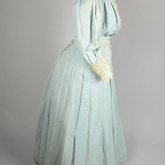 Dress, blue cotton with pouched bodice, tailored skirt, lace yoke, and matching belt, c. 1905, side view