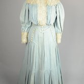 Dress, blue cotton with pouched bodice, tailored skirt, lace yoke, and matching belt, c. 1905, front view