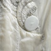 Evening dress, cream panne velvet with rhinestones and embroidery, 1929, detail of interior skirt weight and embroidery